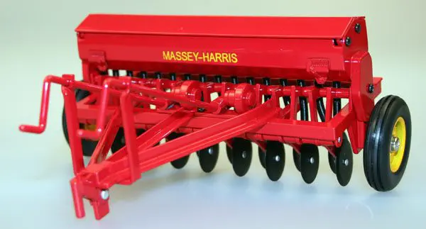 Close-up of a red Massey-Harris agricultural machine part.