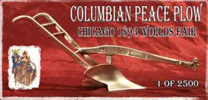 Antique plow with 'Columbian Pea Chicago 1893 World's' inscription on red fabric.