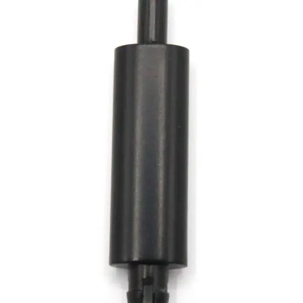 Black cylindrical muffler with attached pipes for vehicle exhaust.