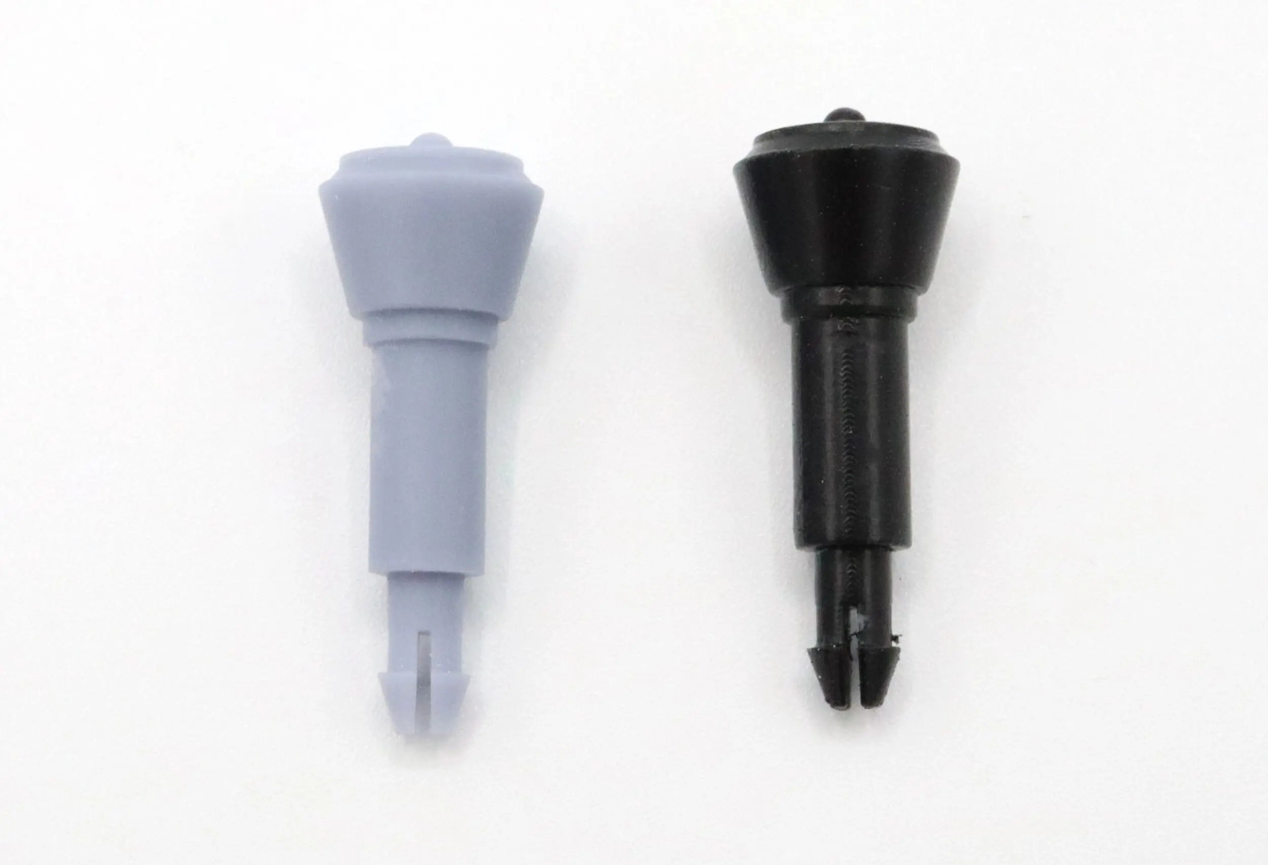 Two plastic components, one gray and one black, with a similar shape and cylindrical design.