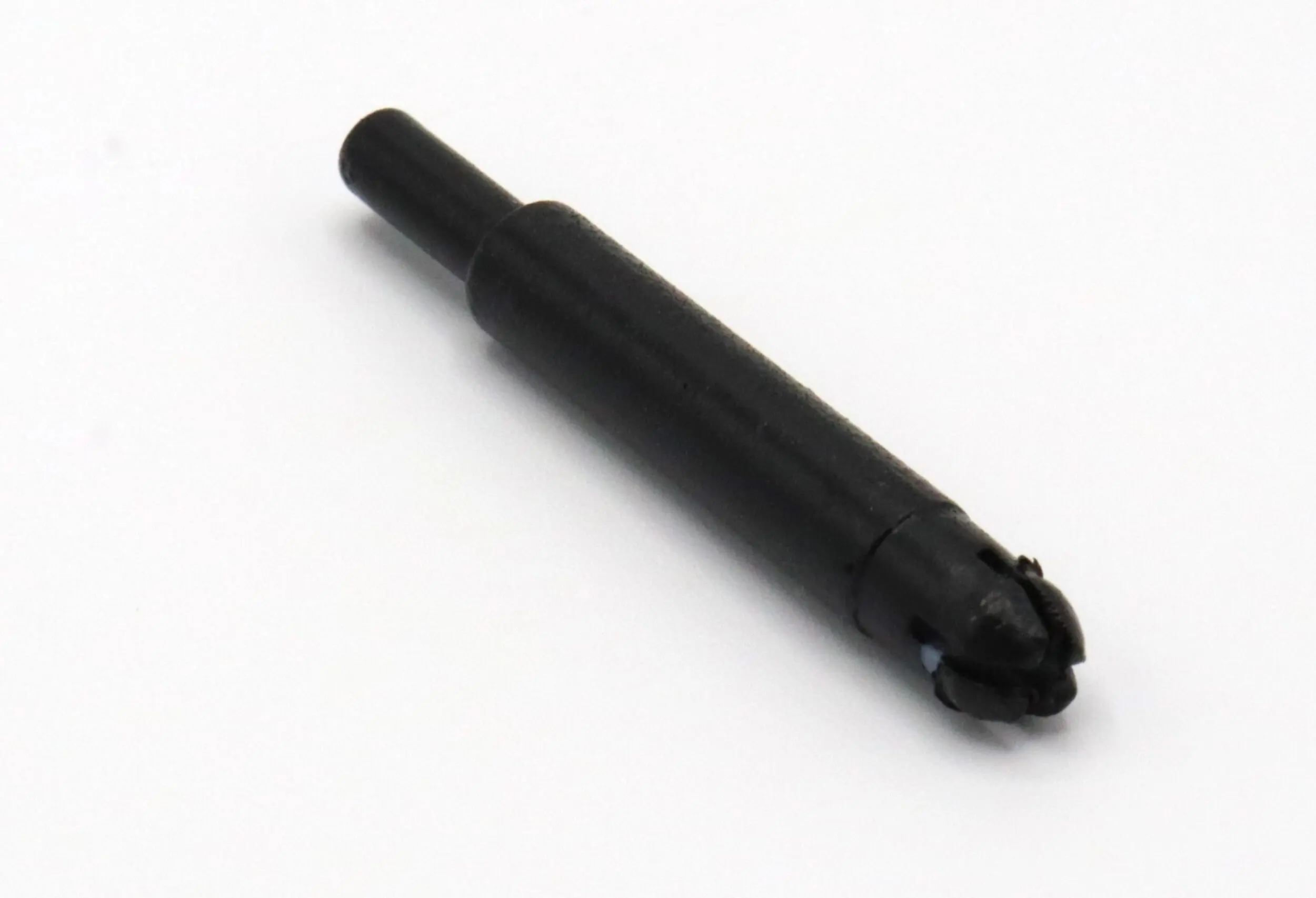 Black plastic ink cartridge for a pen.