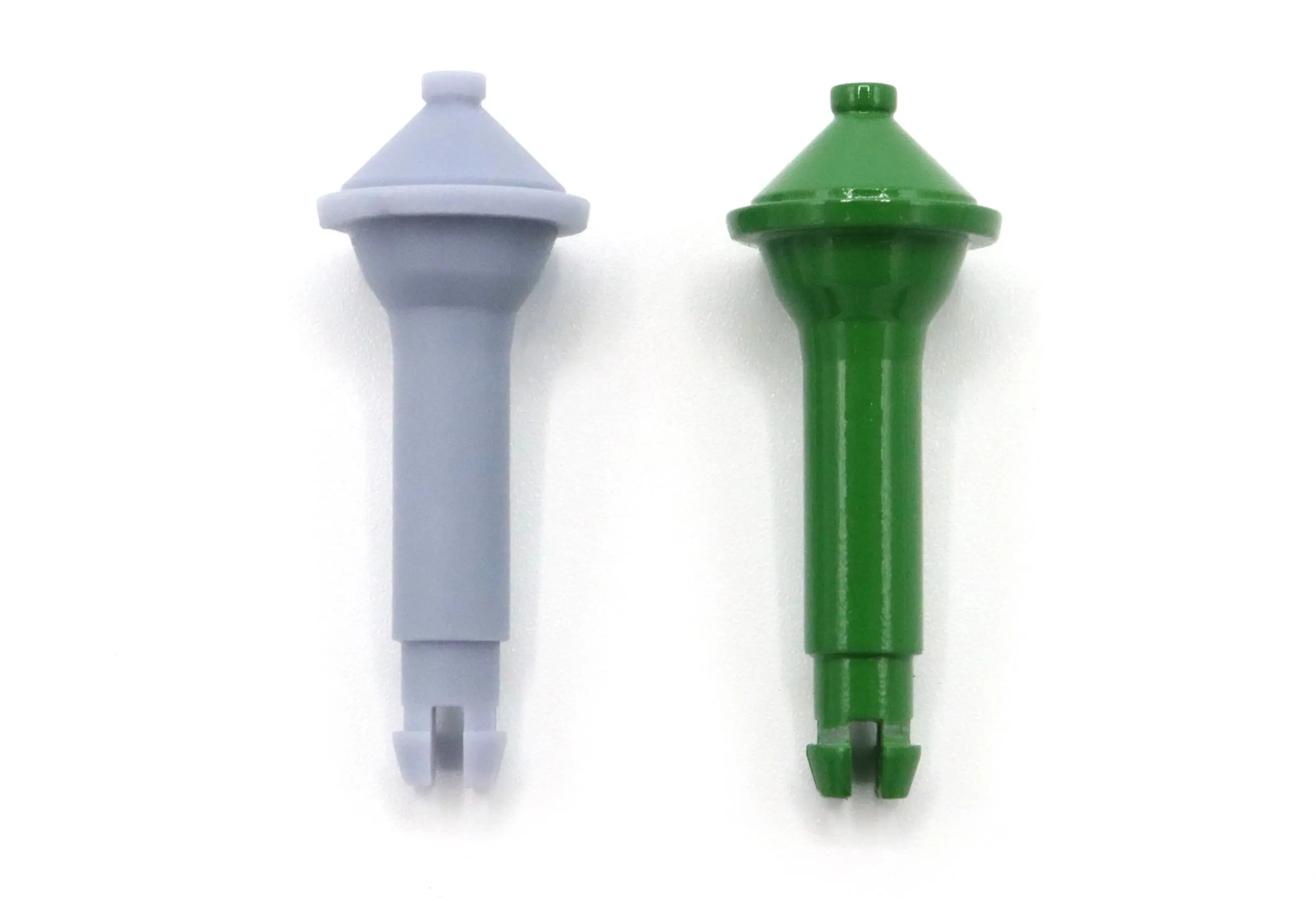 Two plastic sprinkler nozzles, one gray and one green, side by side.