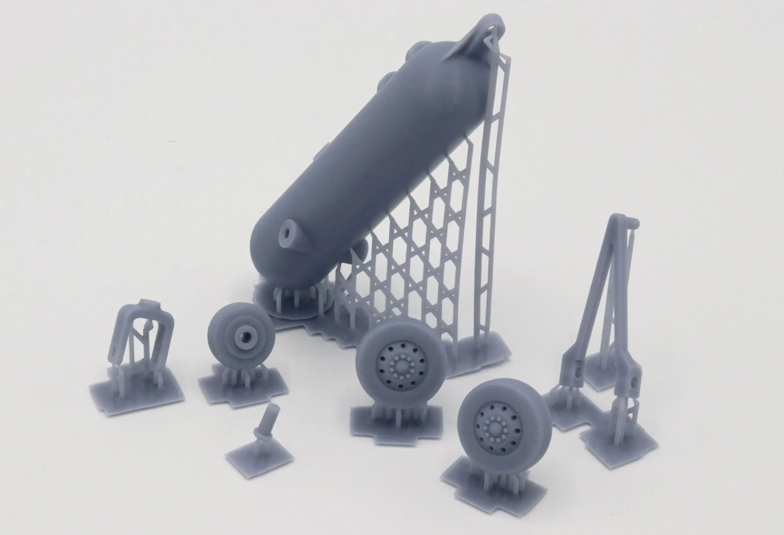 Miniature model parts arranged on a flat surface.