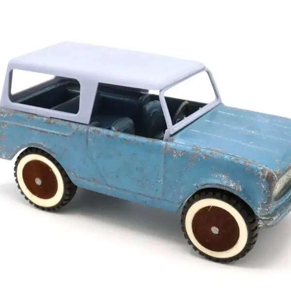 A vintage toy car with a blue body and white top.