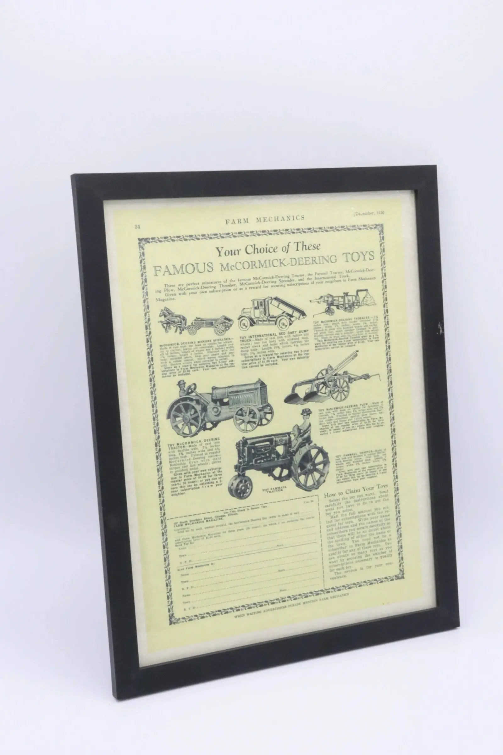 Framed vintage tractor advertisement with detailed illustrations and text.