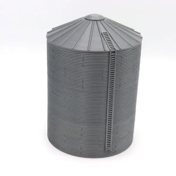 A tall, cylindrical black metal silo with a conical roof and vertical ladder.