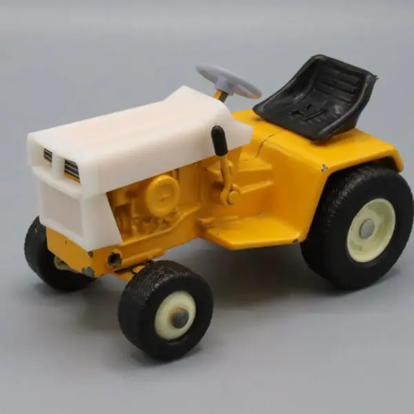 A small yellow and white toy tractor with black wheels.
