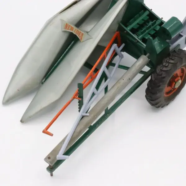 Close-up of a green agricultural machine's wheel and metal components.