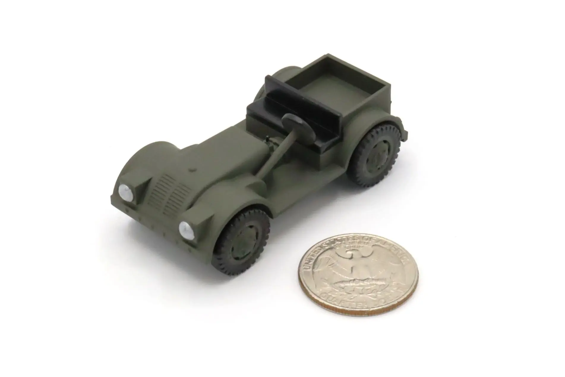 Small green toy jeep next to a coin for size comparison.