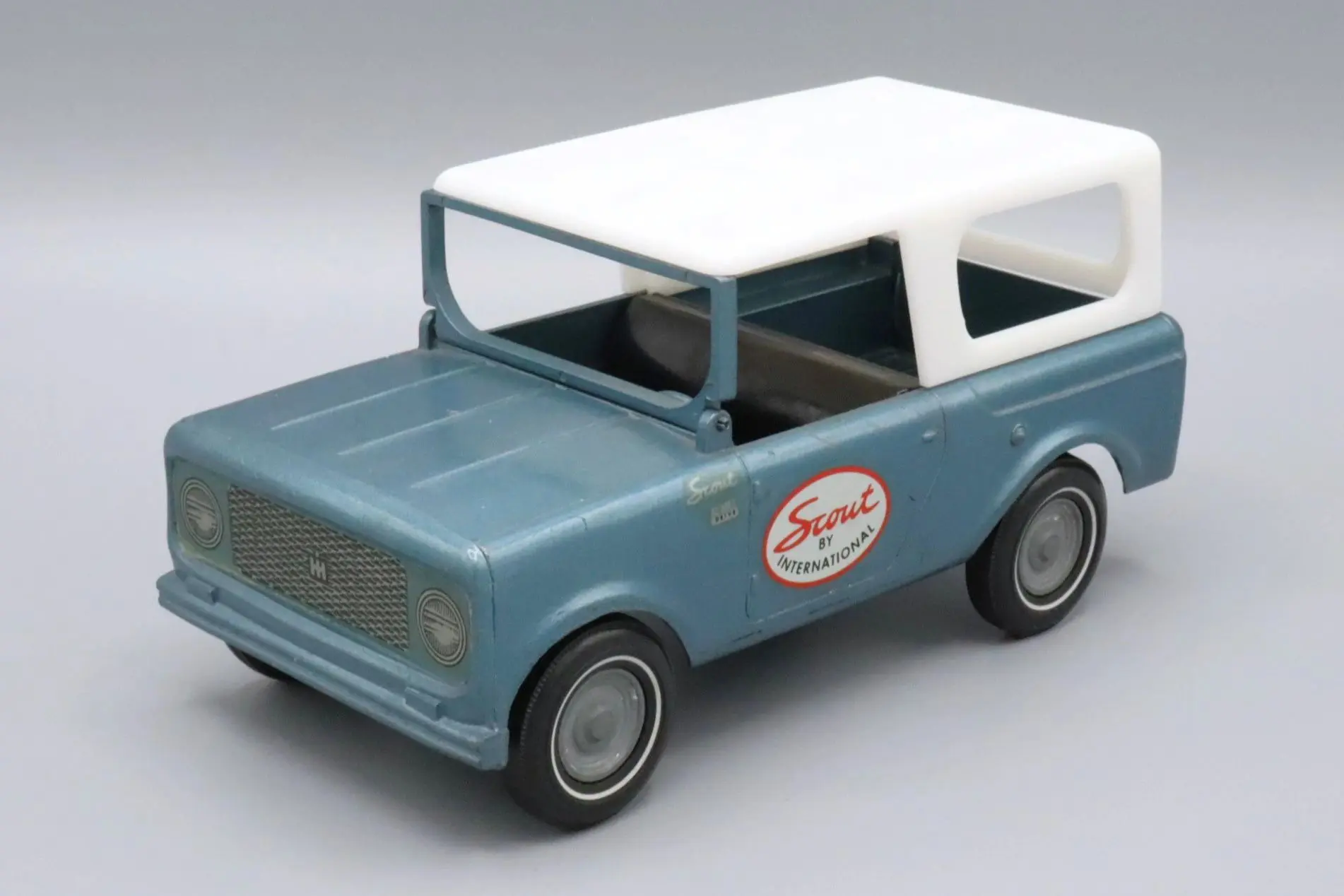 Vintage blue and white toy car with a 'Fire Dept' logo on the door.