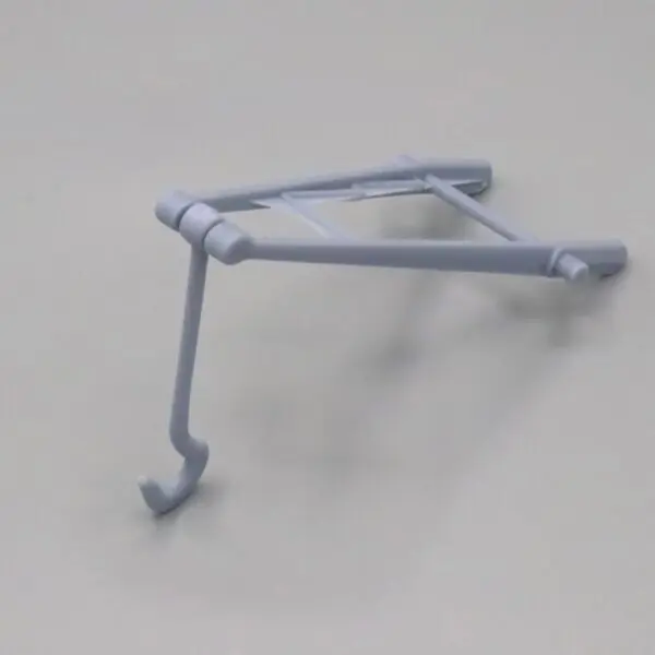 A white wall-mounted metal bracket with a hook.