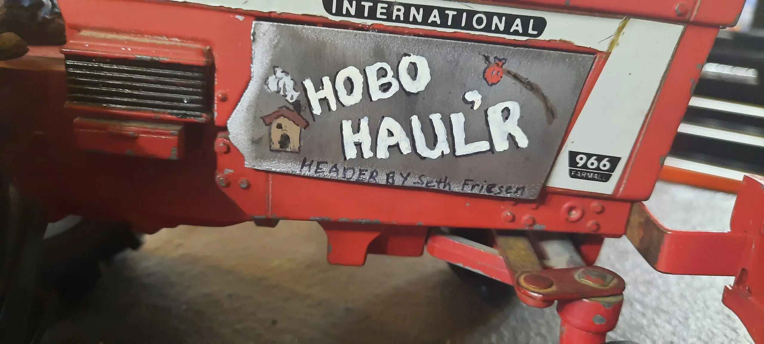 Red trailer labeled 'Hobo Haul'r' with a humorous design and paw print.