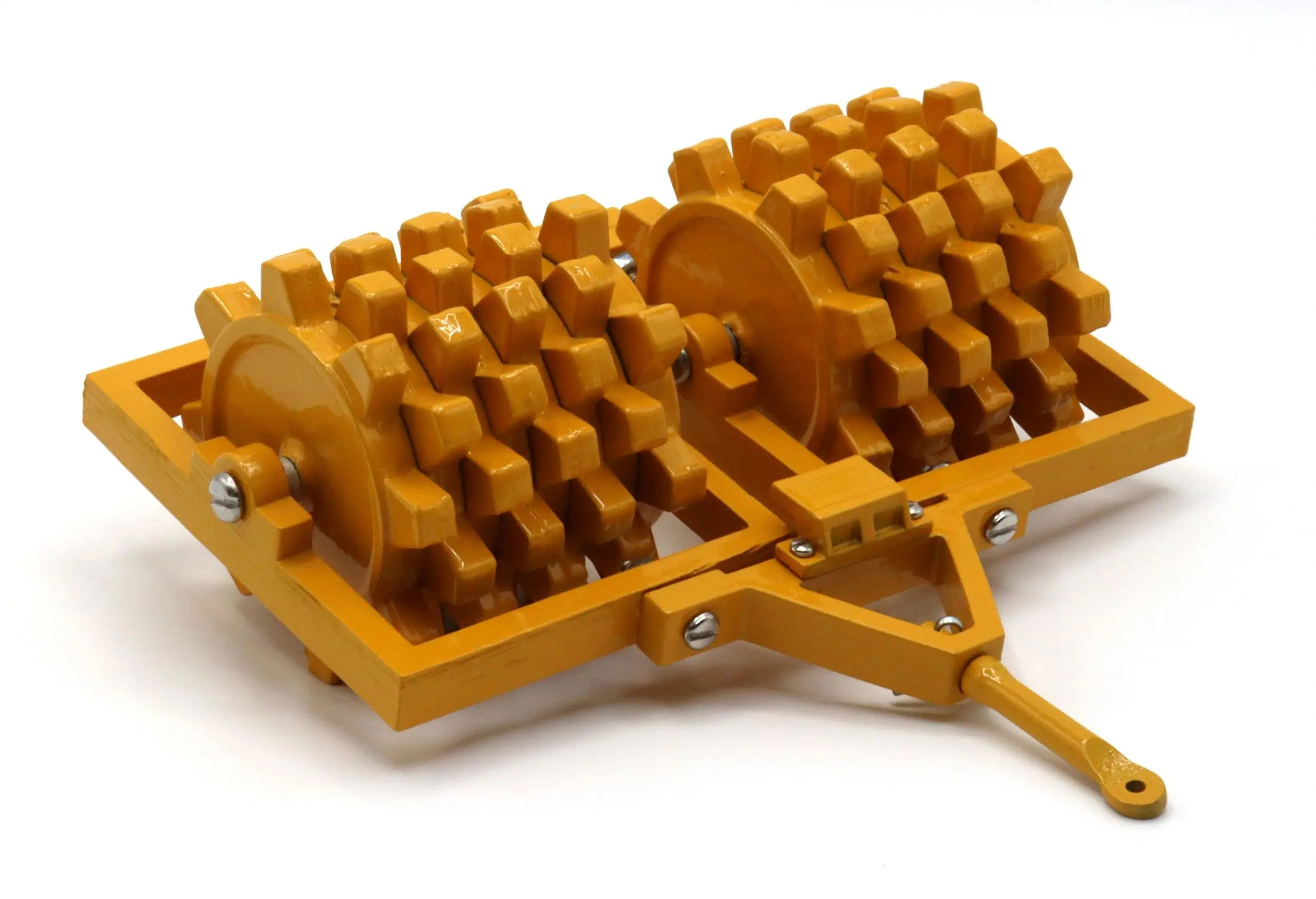Heavy-duty yellow agricultural roller with spiked wheels for soil preparation.