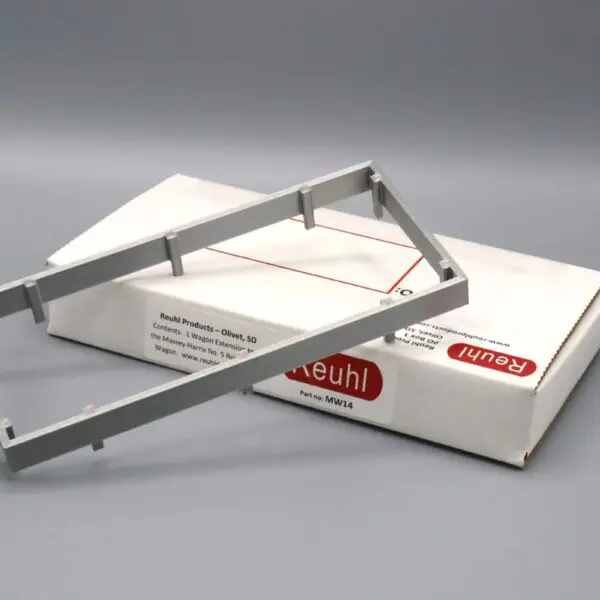 Two metallic rectangular frames with packaging boxes on a gray surface.