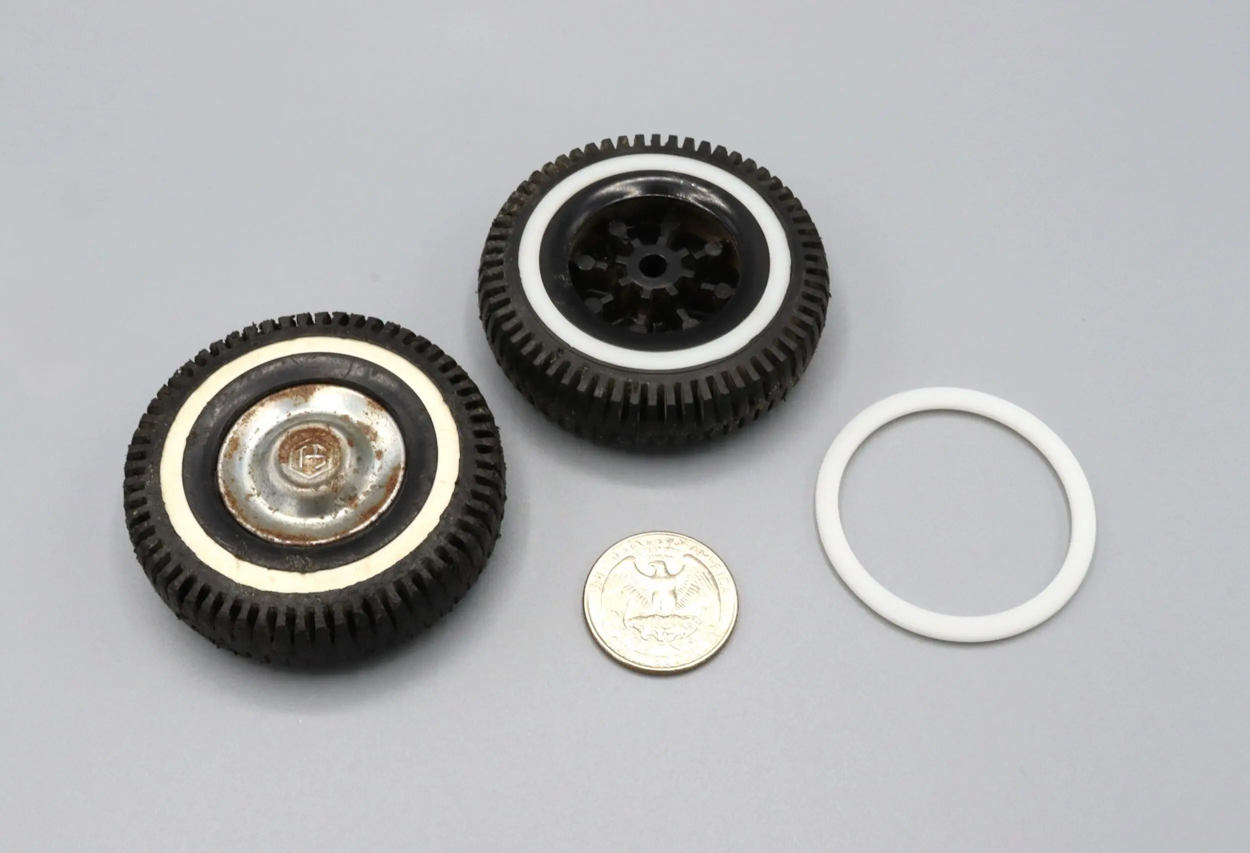 Disassembled small wheels and a coin for size comparison.