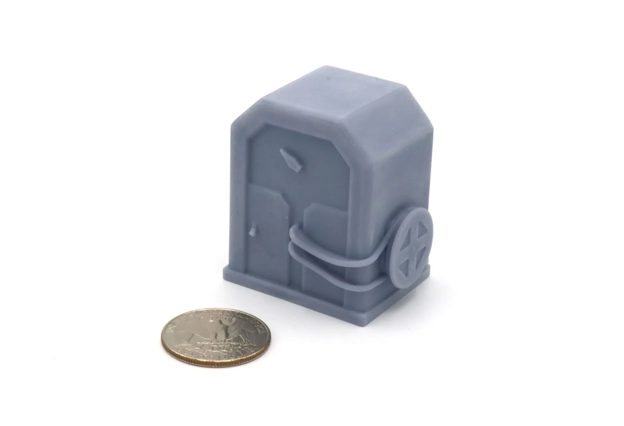 A small gray sci-fi container with a coin for scale.