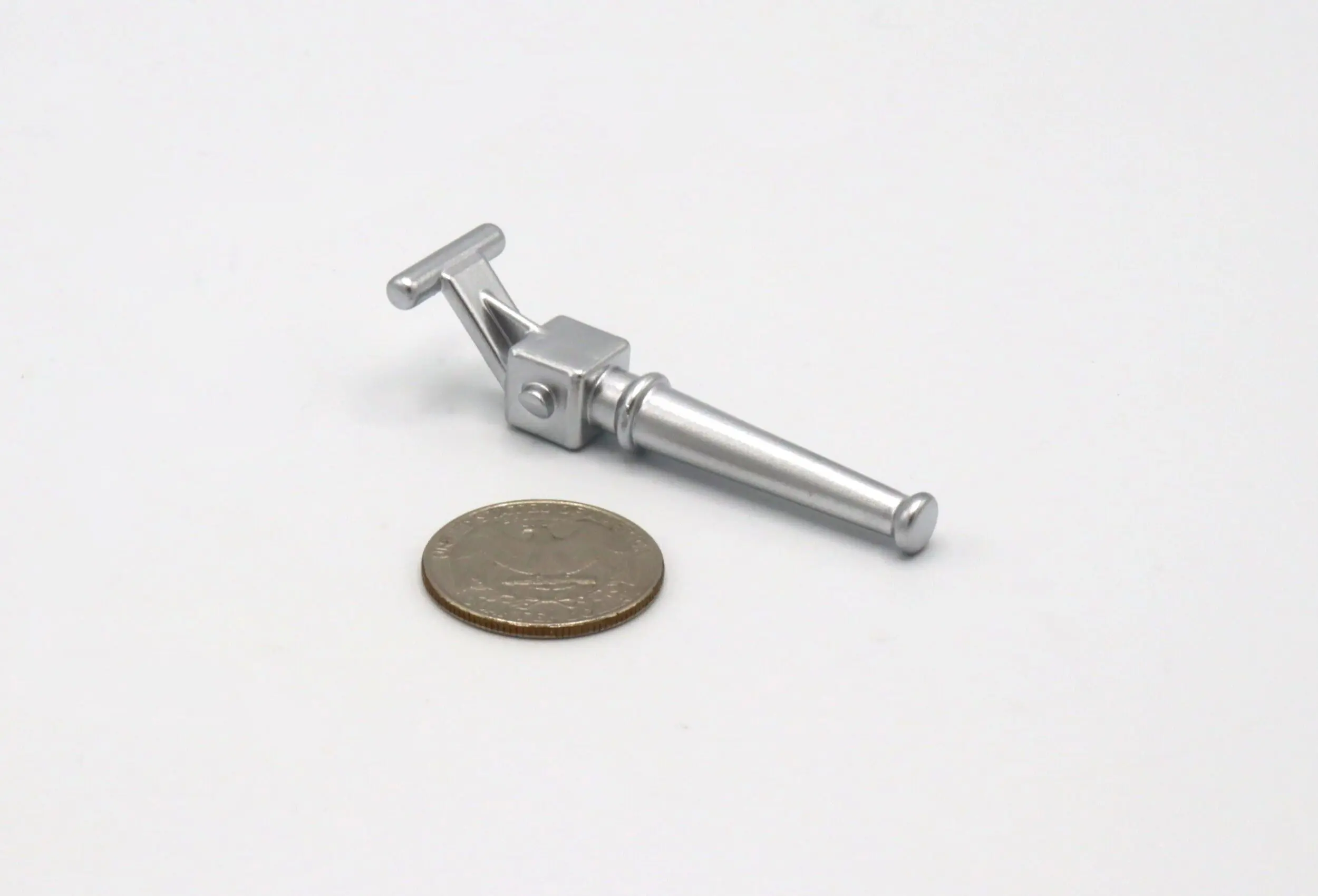 Close-up of a metal tuning peg next to a coin for scale.