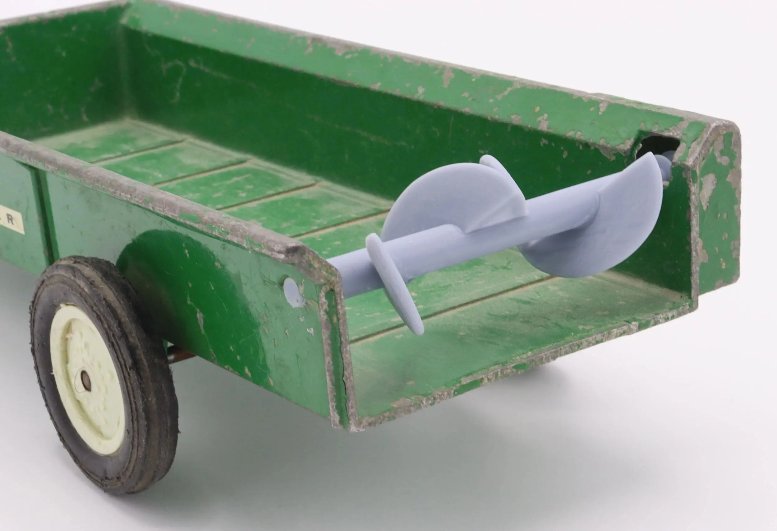 A green wooden wheelbarrow with a metal handle and a single black wheel.