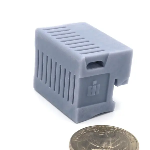 Small gray electronic component with ventilation slots and a switch.