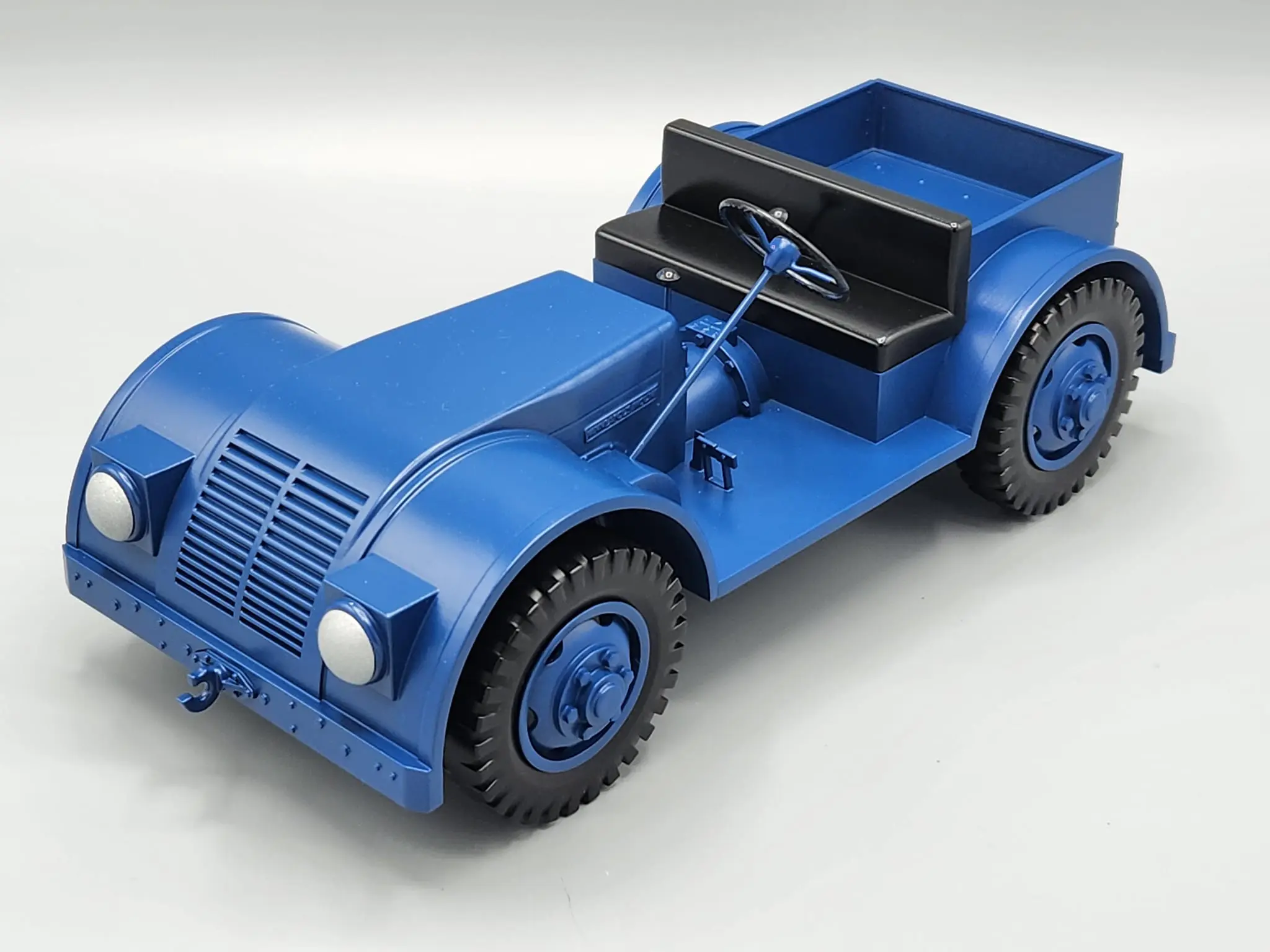Blue vintage-style toy car with detailed design and black interior.