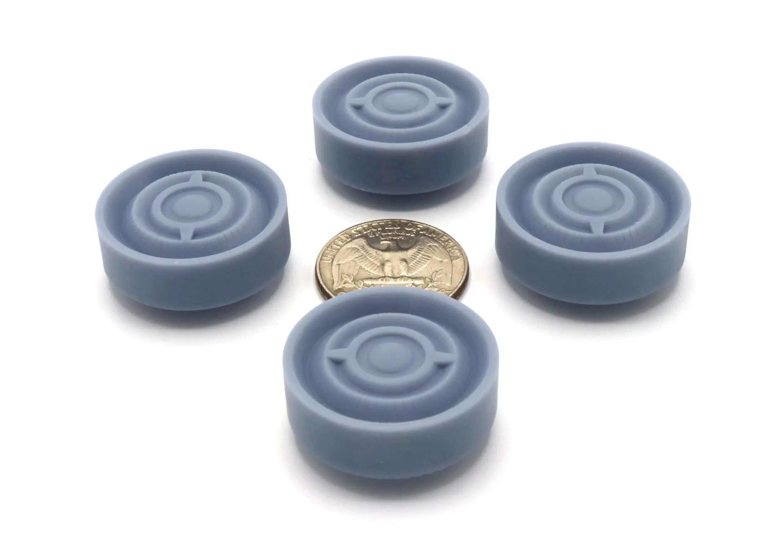 Four gray round objects around a coin.