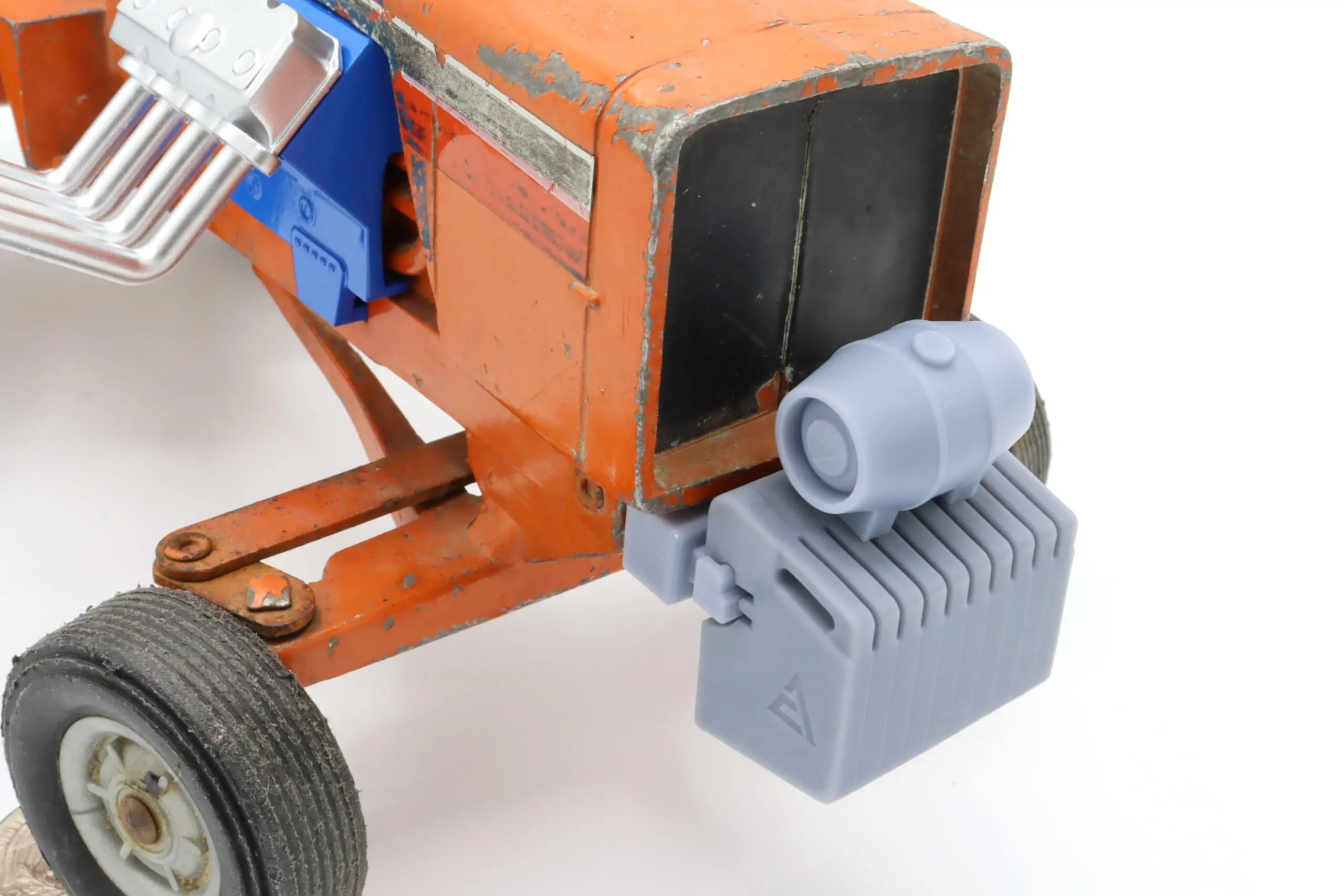 Toy tractor with orange body and blue parts.