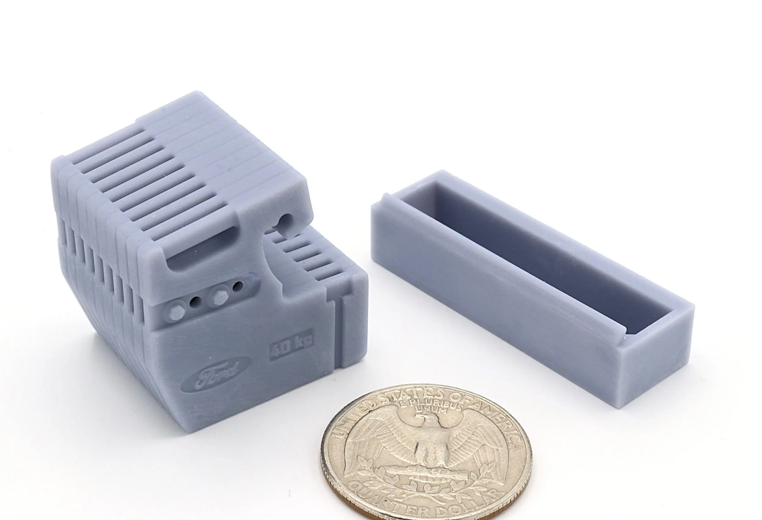 Small gray plastic components beside coin.