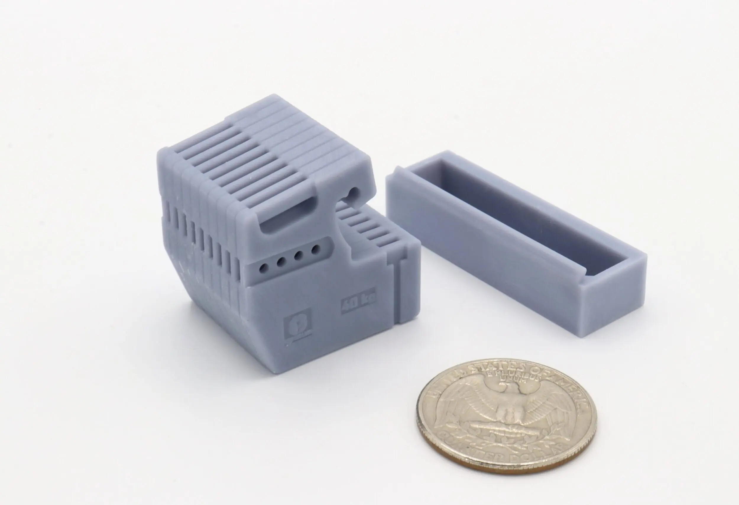 Small plastic component beside a coin.