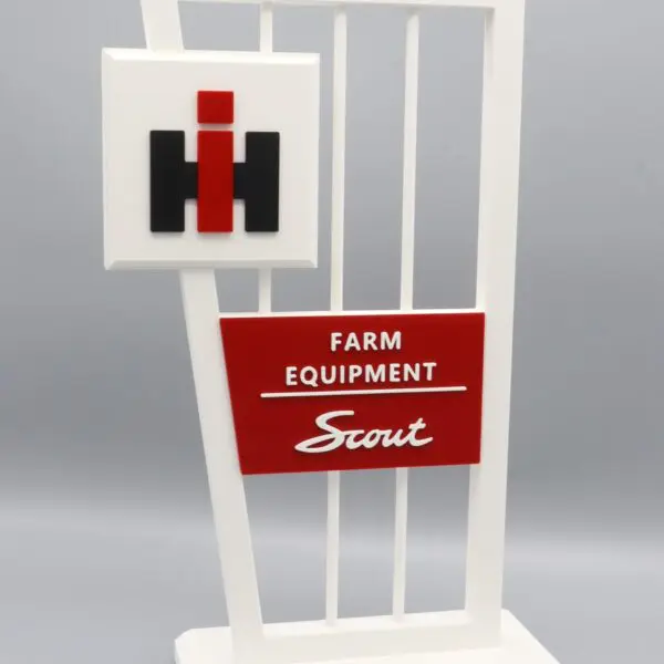 Farm equipment sign with red and black.