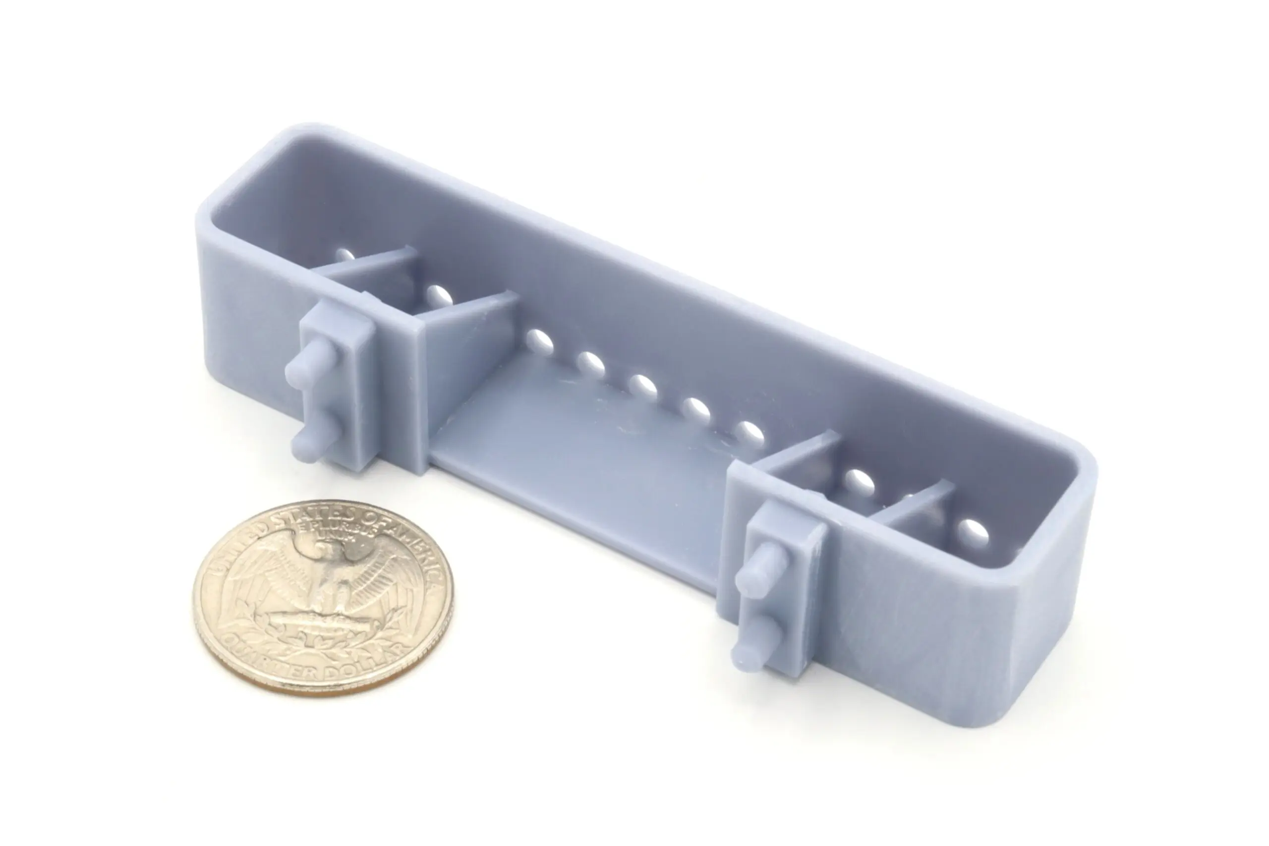 Gray plastic clip with coin for scale.
