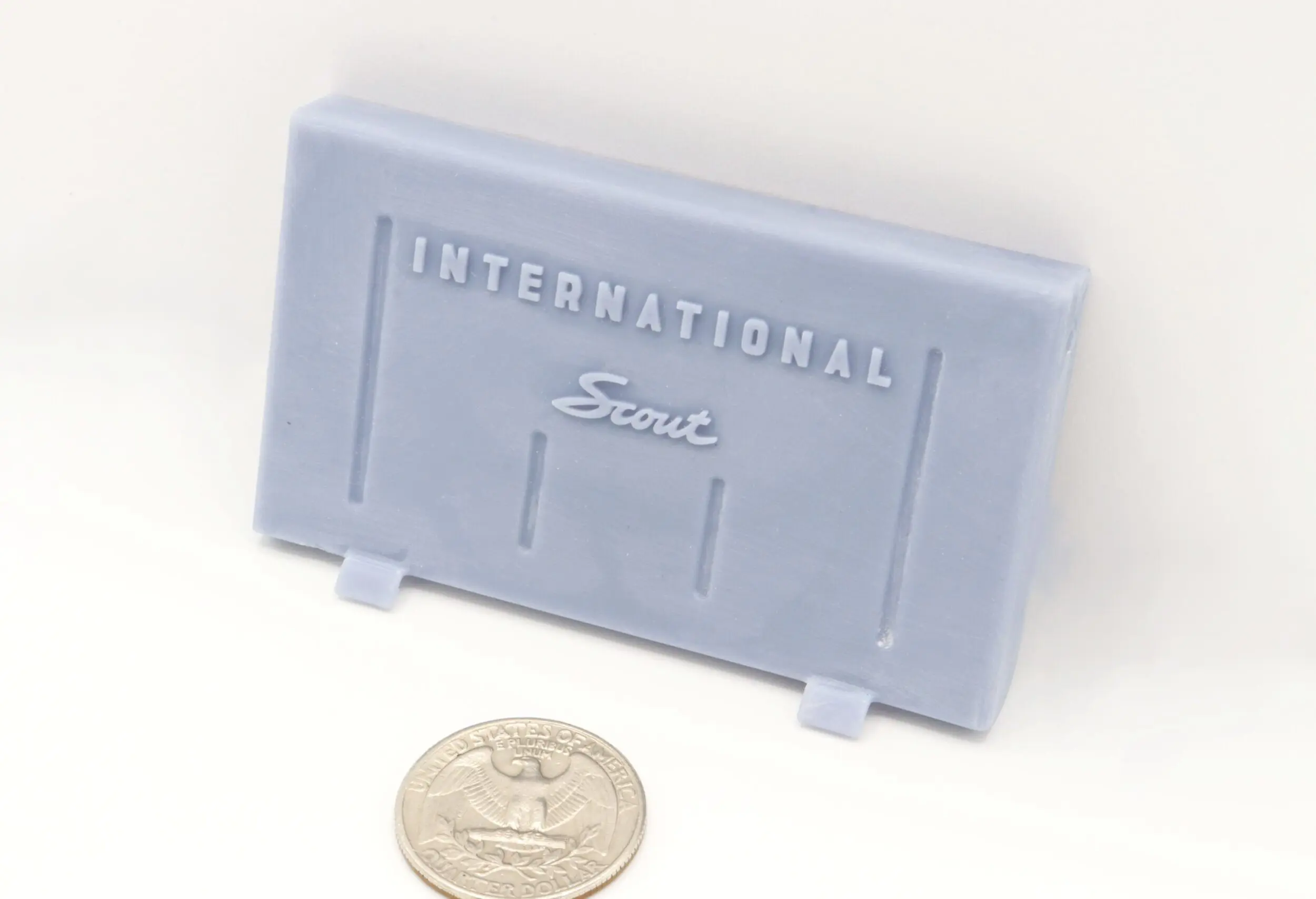 Model car part with quarter for scale.