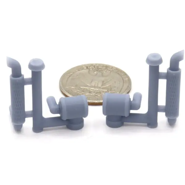Miniature parts with coin for scale.