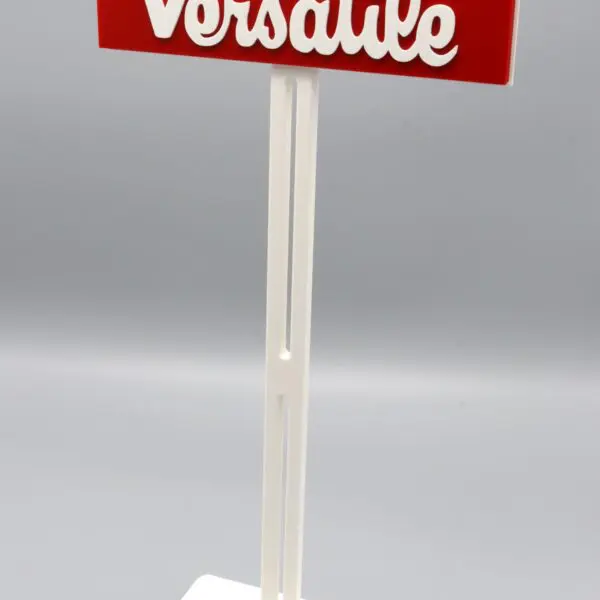 Red "Versatile" sign on white stand.