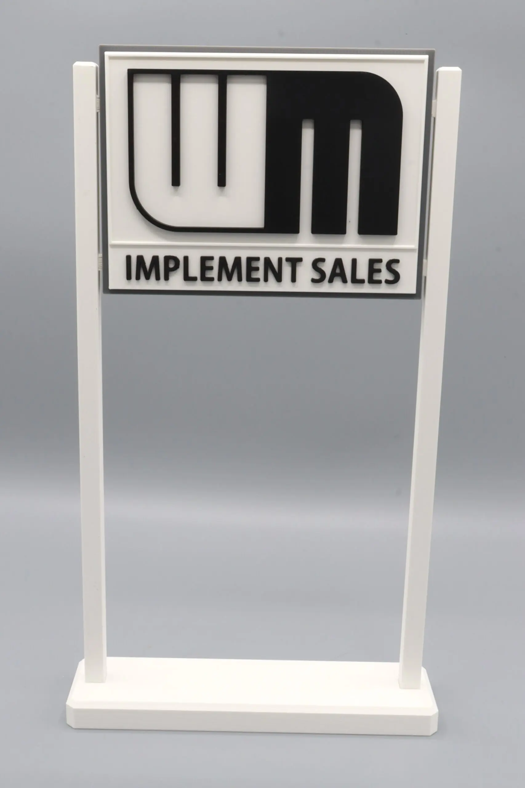 Sign with "WM Implement Sales" text.