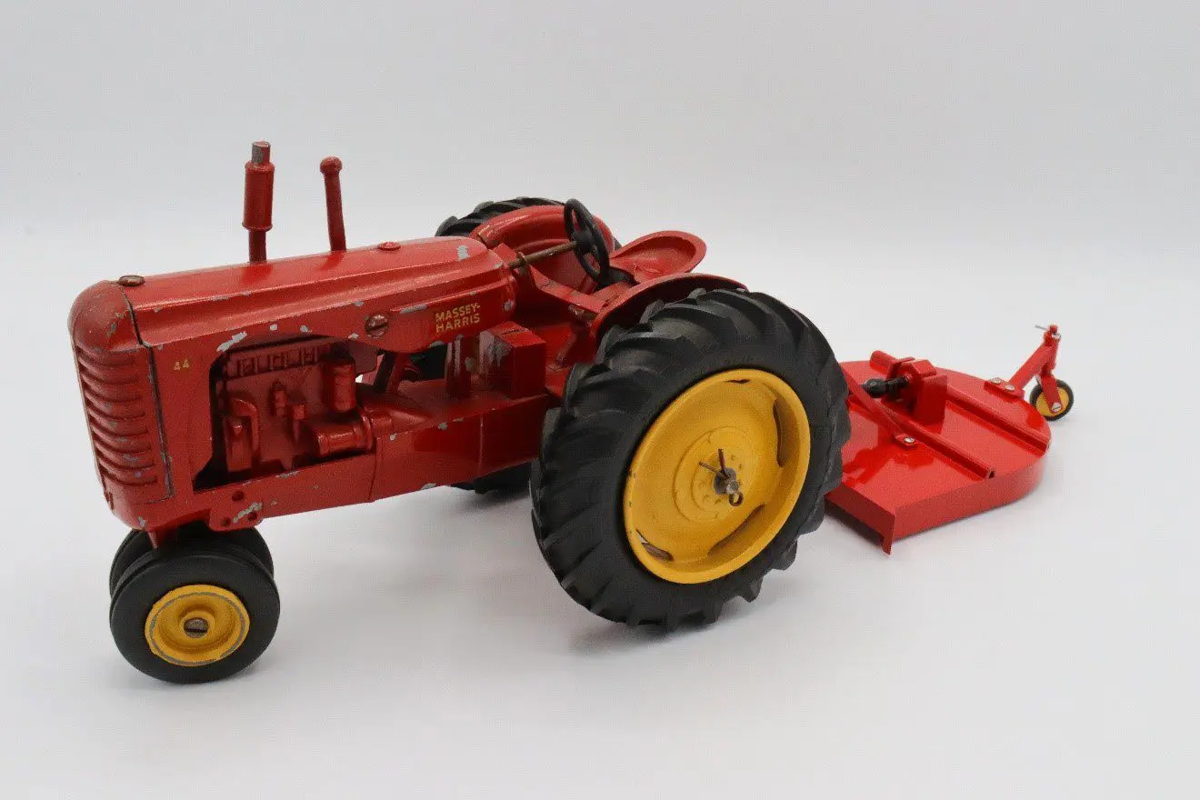 Red toy tractor with yellow wheels.