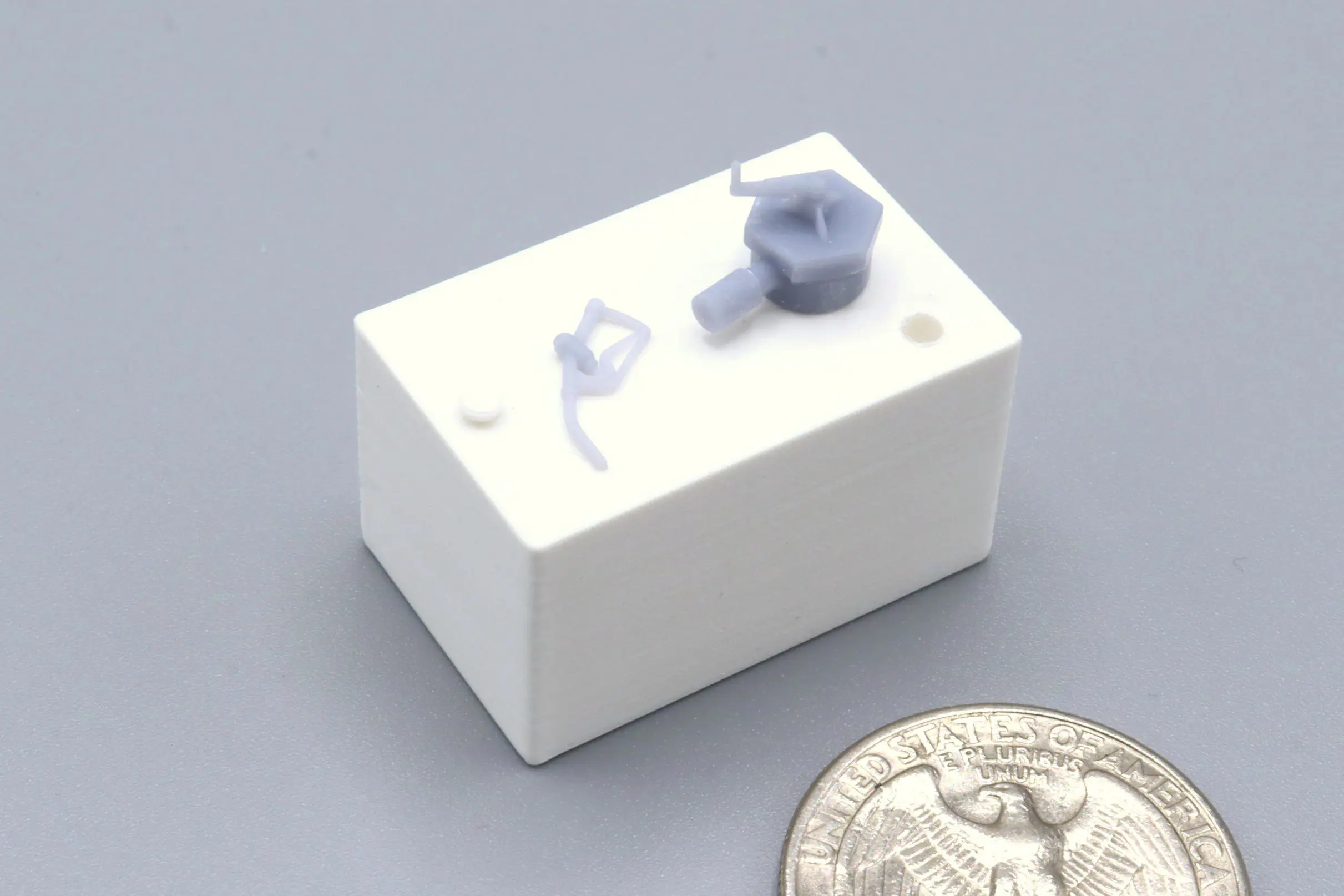 White block and coin on gray background.