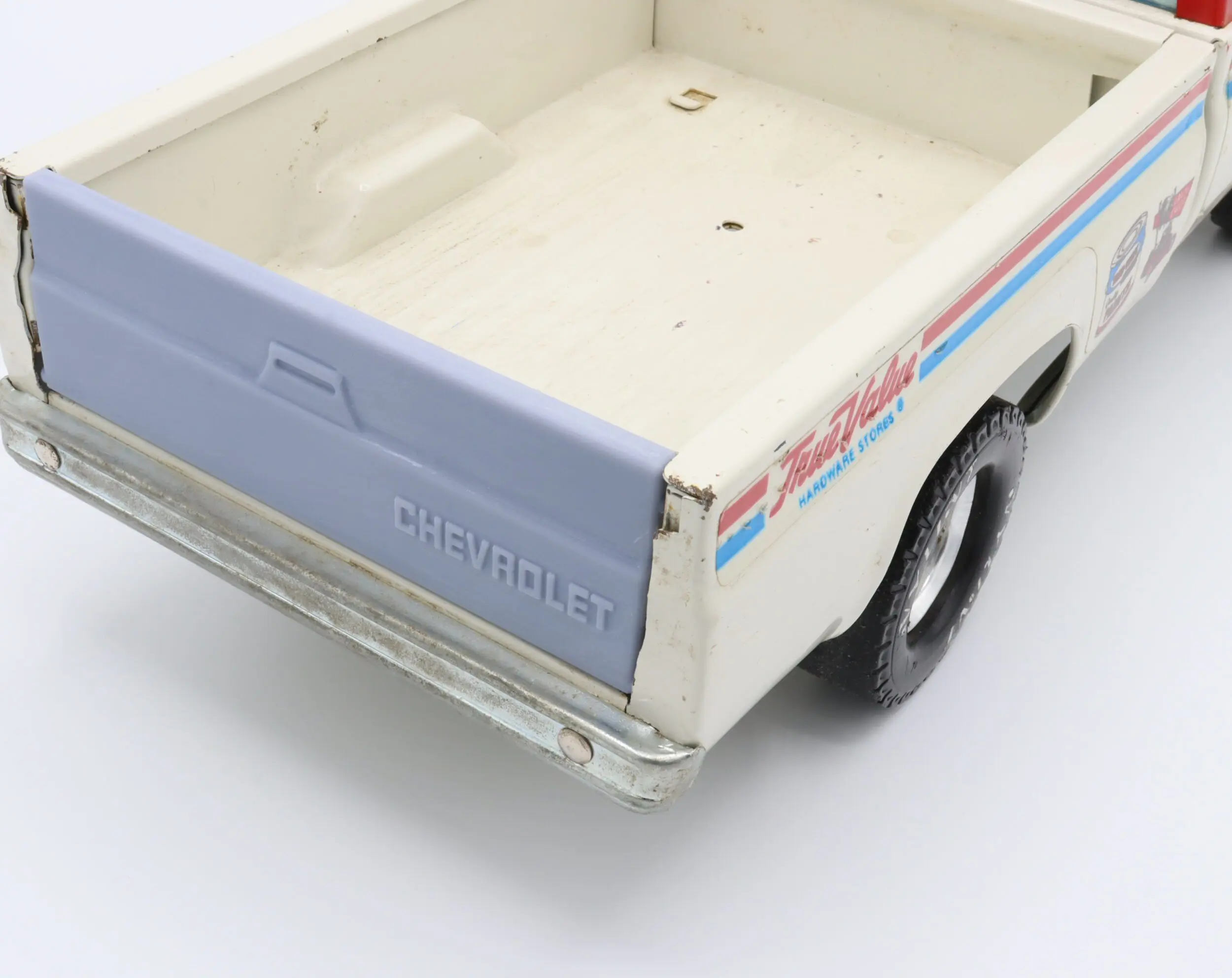 Toy Chevrolet truck with open flatbed.