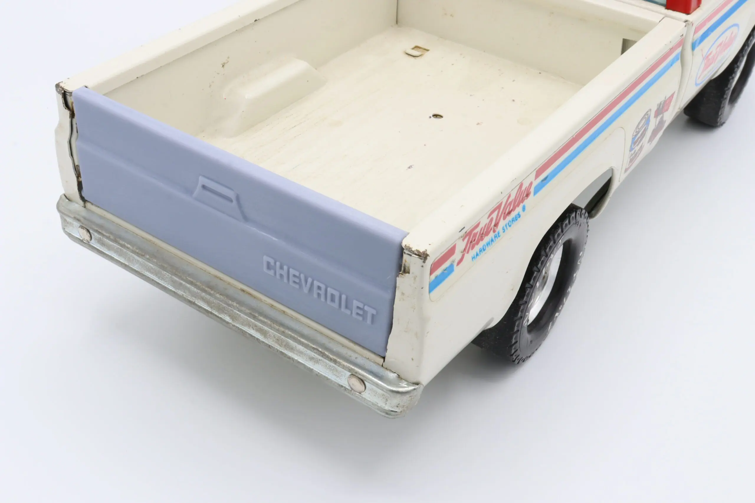 Toy Chevrolet truck with open flatbed.