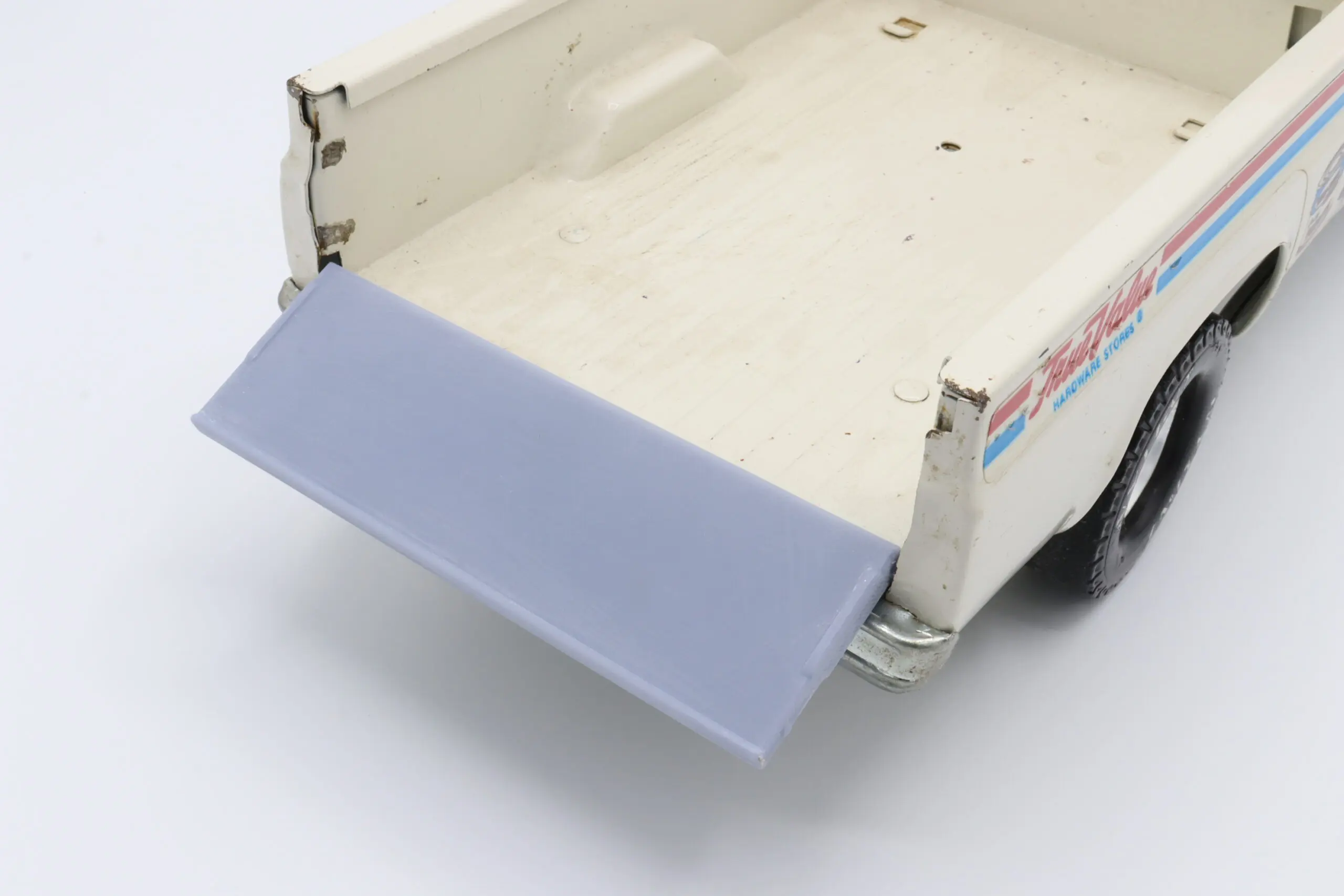 Toy truck bed with blue tailgate.