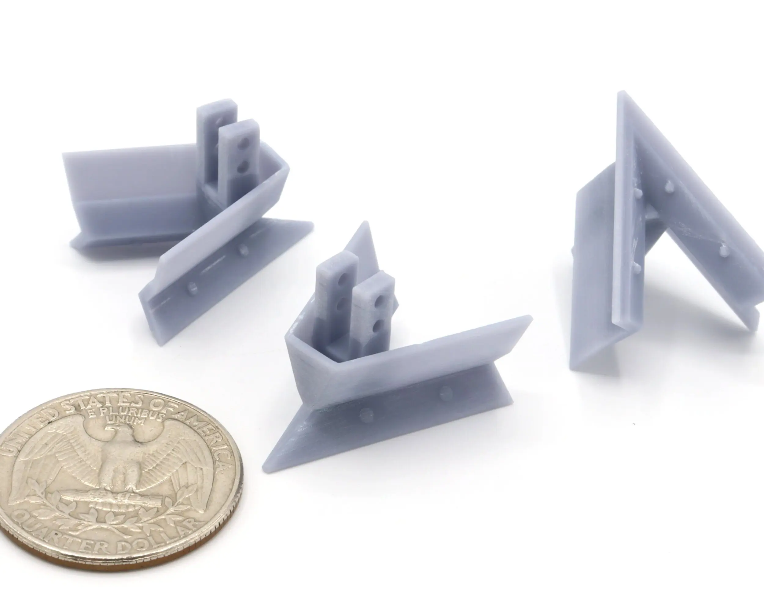 Gray plastic clips beside a coin.