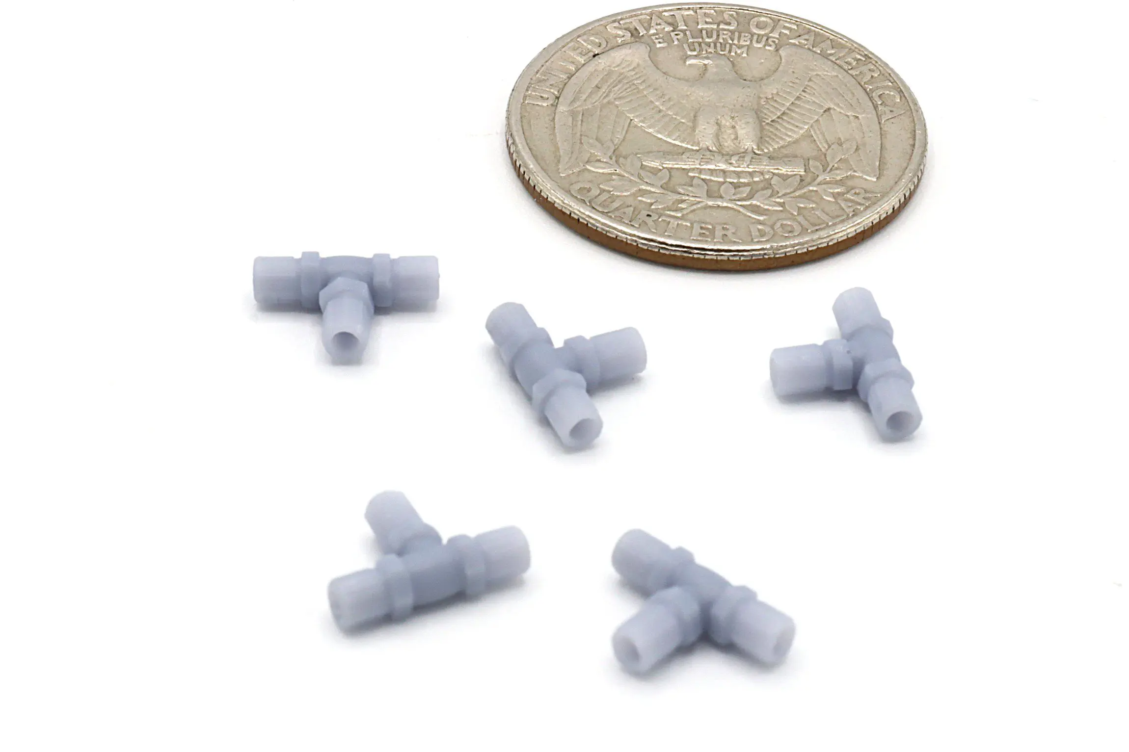 Tiny gray connectors next to a coin.