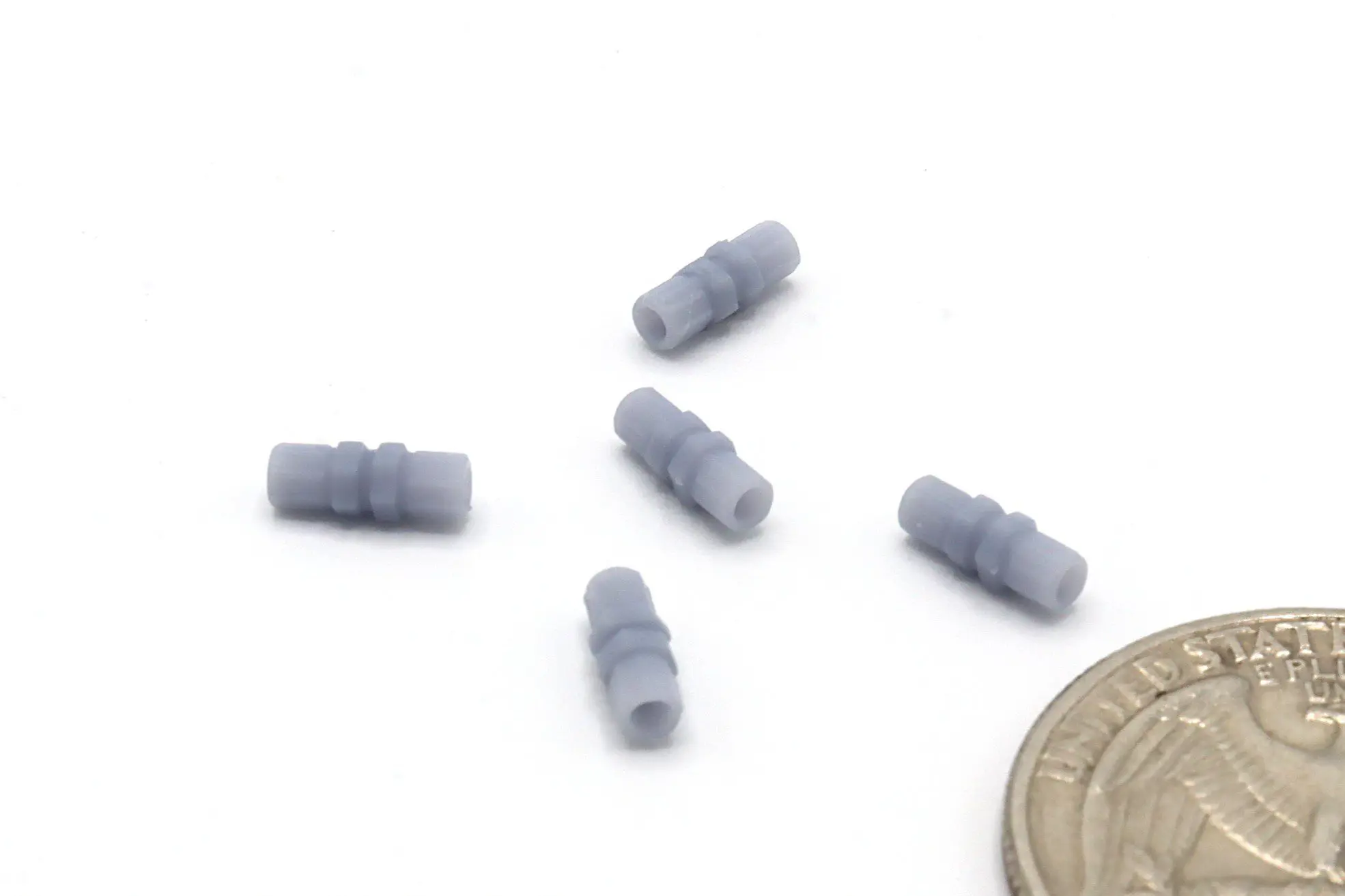 Small gray connectors beside a coin.