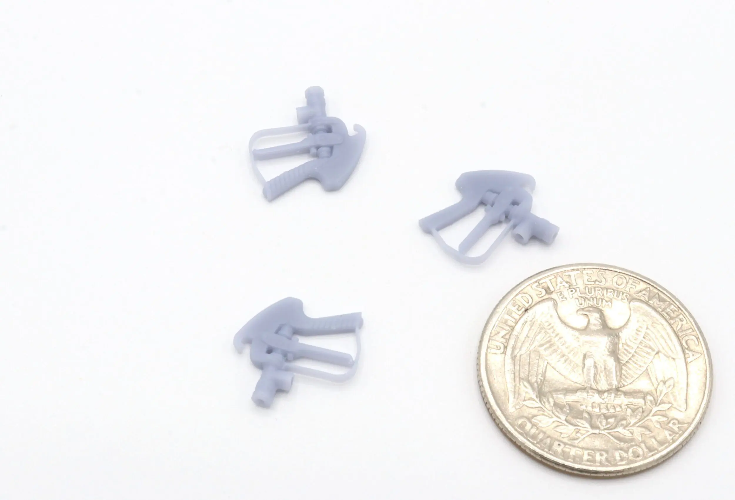 Small gray objects next to a coin.