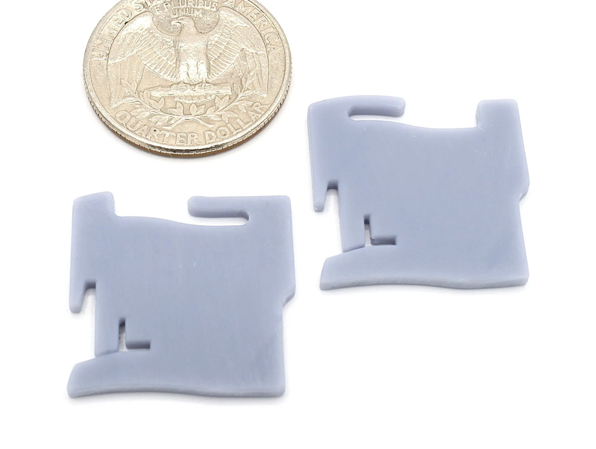 Two gray clips beside a quarter coin.