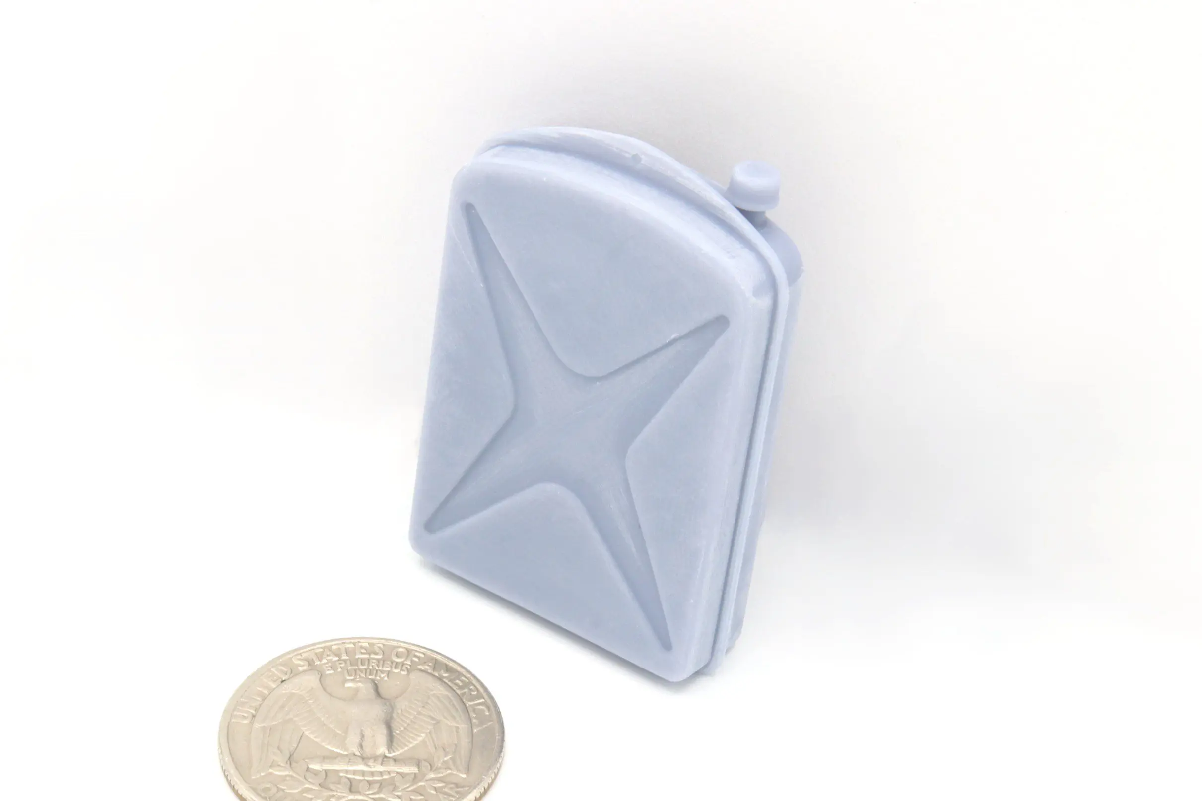 Miniature jerry can next to a coin.