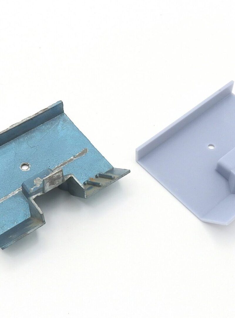 Two small plastic parts, one blue and one white, placed side by side.