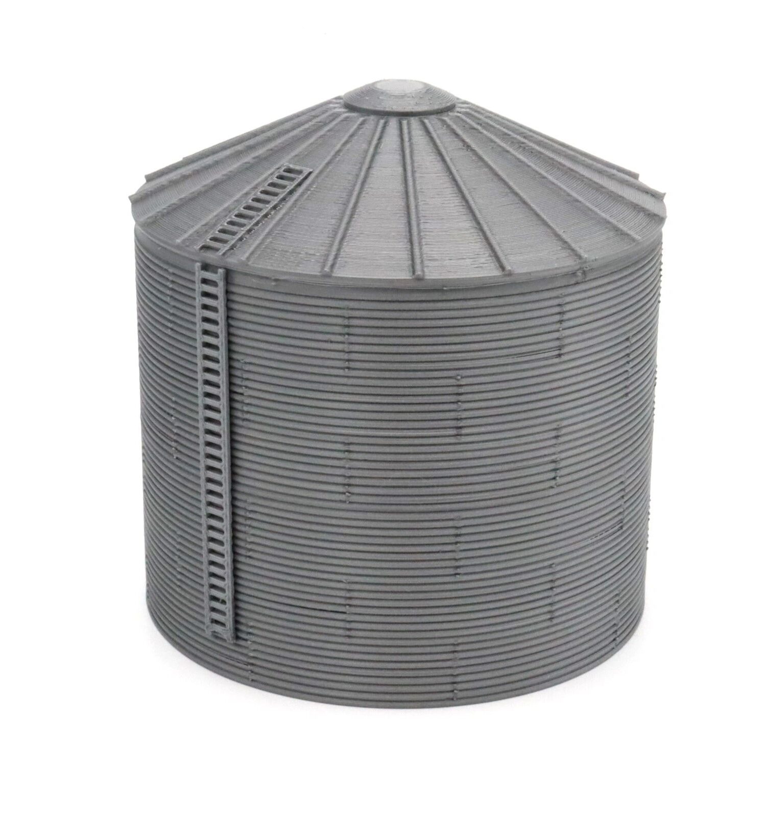 A large metal grain silo with a conical roof and ladder.