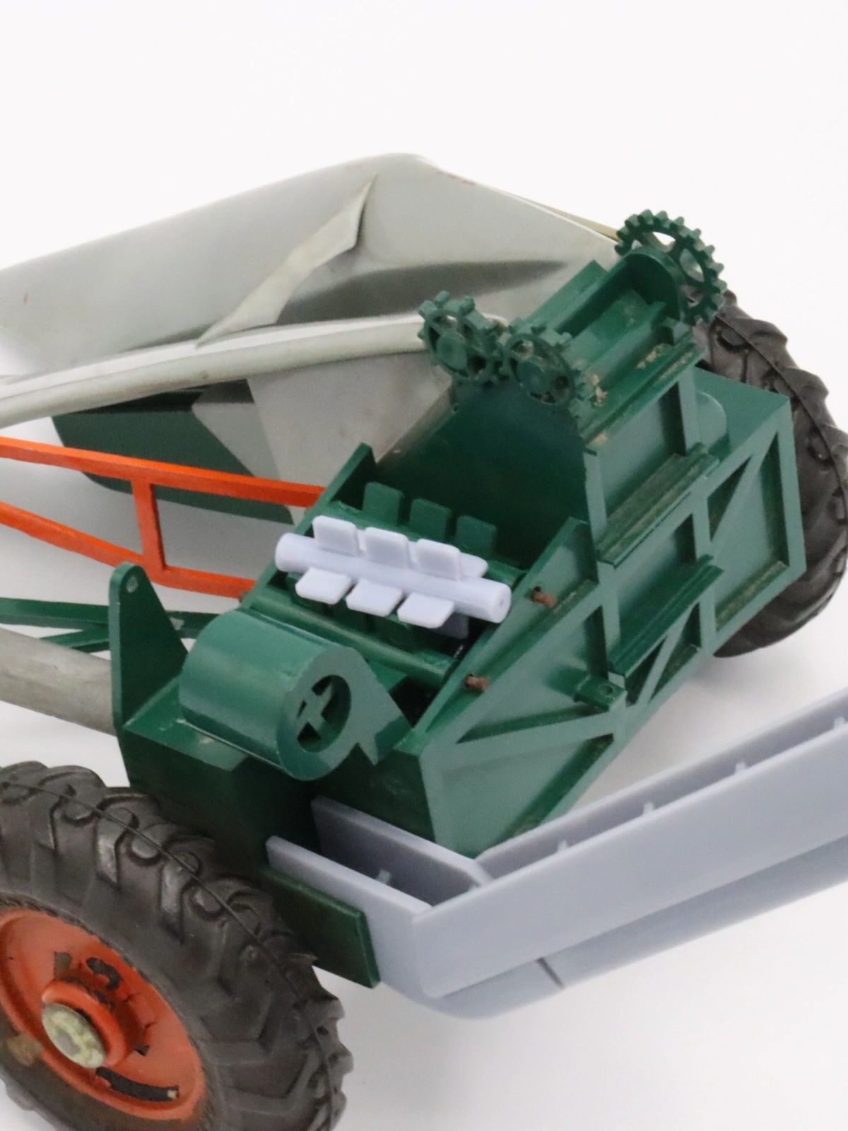 Close-up of a model tractor's rear with engine and wheel details.
