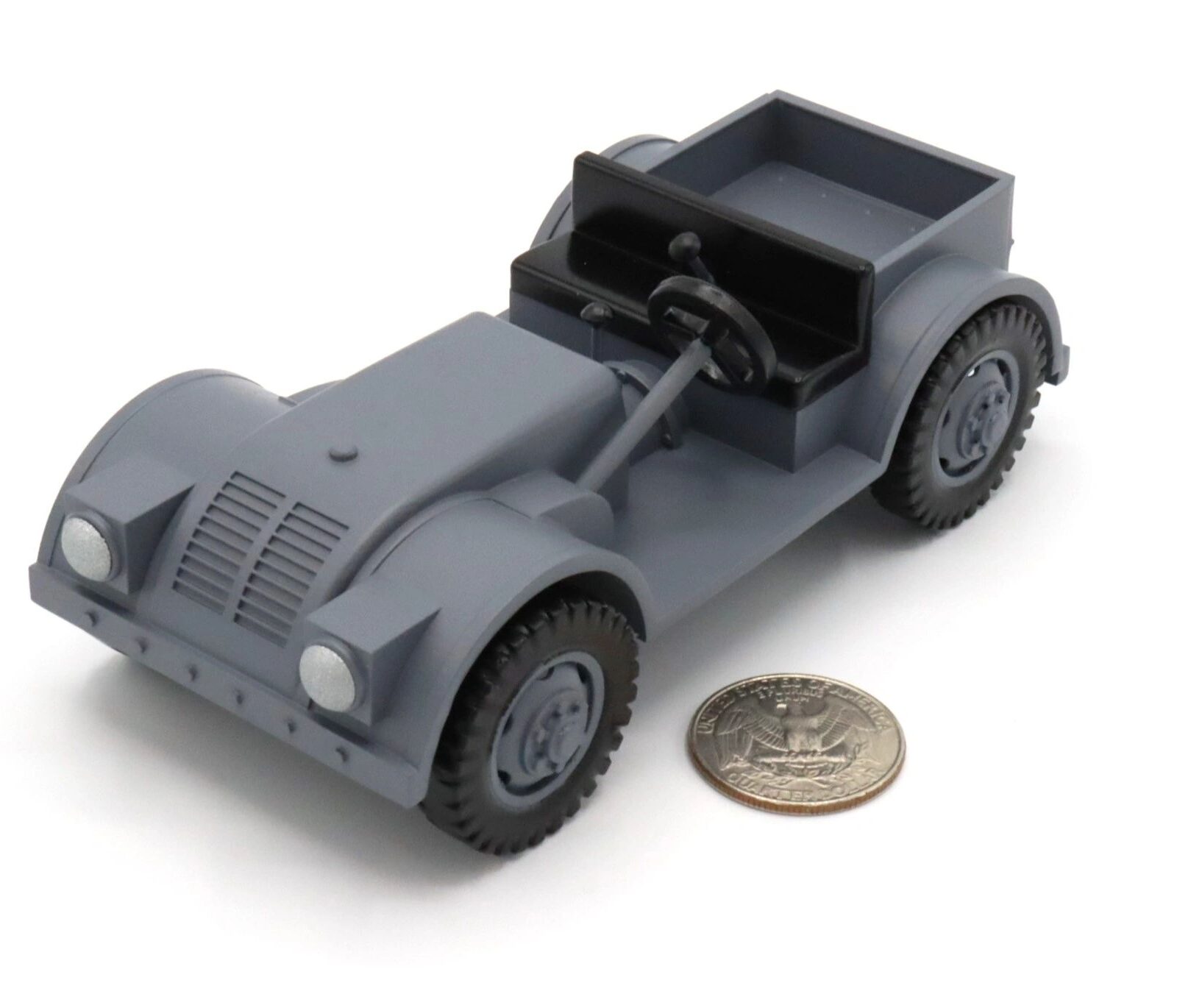 Small gray toy car next to a coin for scale.