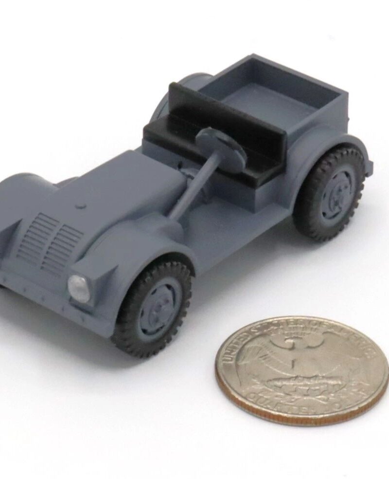 A small gray toy car next to a coin for size comparison.